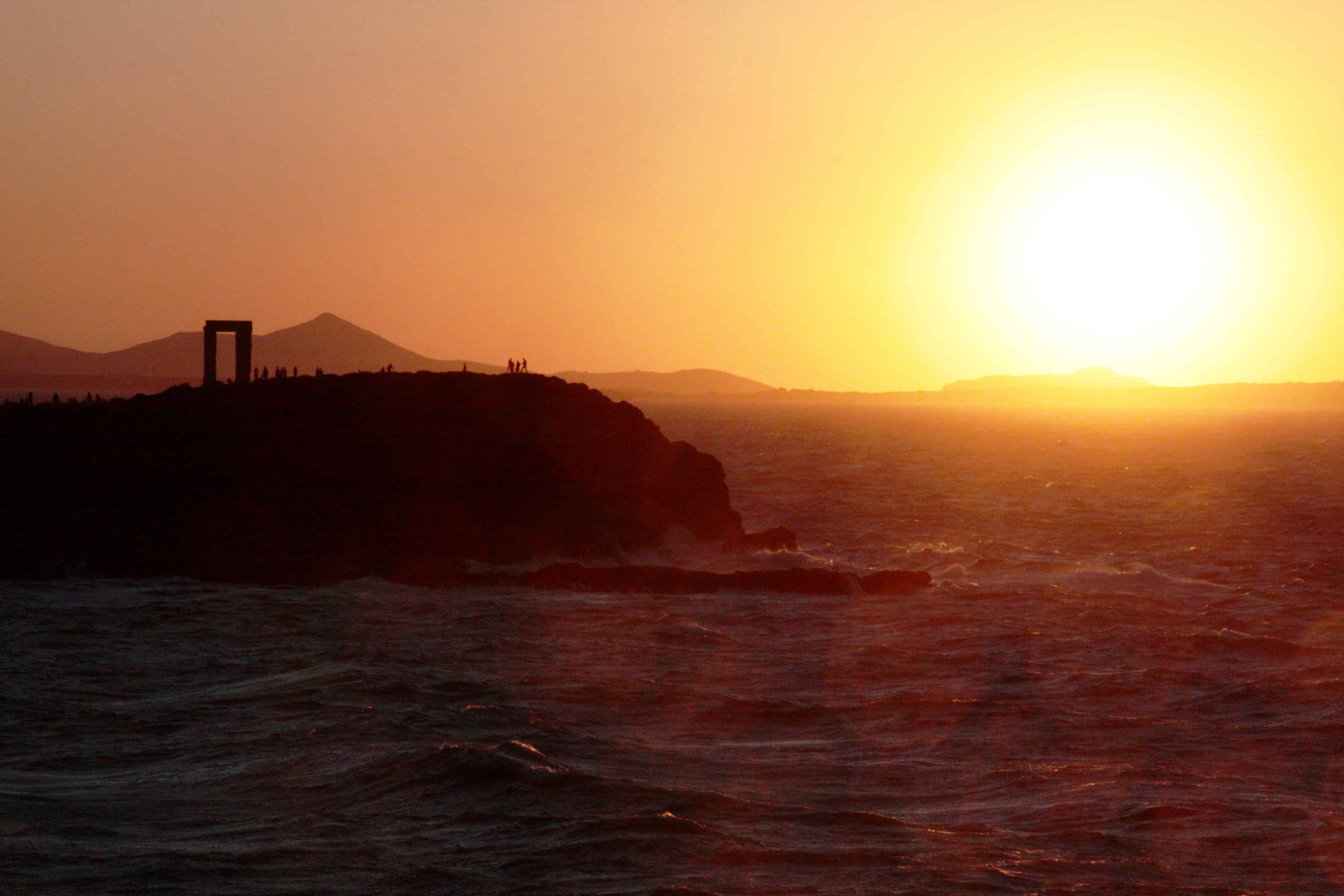 The sun sets behind the Portara gateway on the Greek island of Naxos.