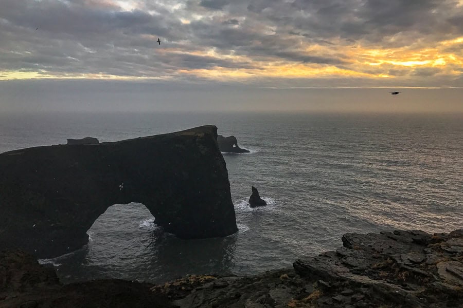 A large rock arch rises from the sea on Day 4 of our 7 day itinerary for Iceland. 