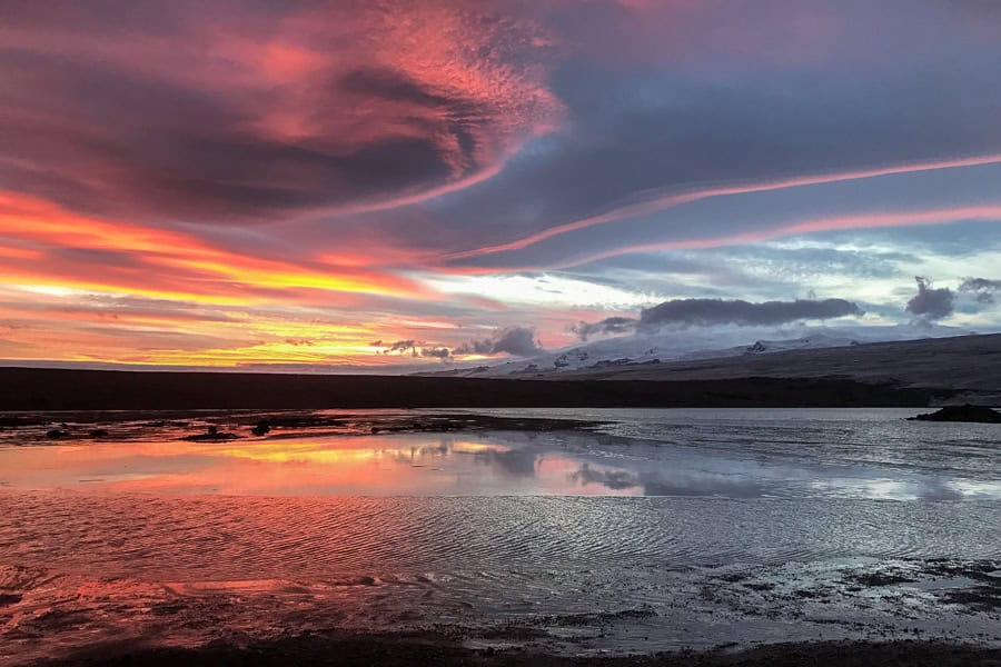 A fiery sunset at Jökulsárlón Glacier Lagoon during winter in Iceland.