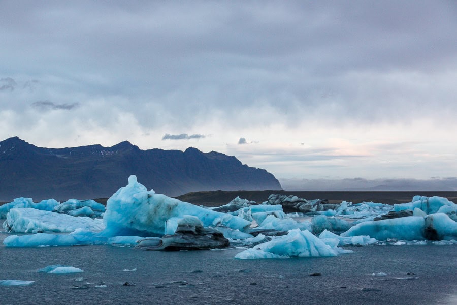 Jagged blue icebergs float on beautiful Jökulsárlón Glacier Lagoon, one of the highlights of southern Iceland.