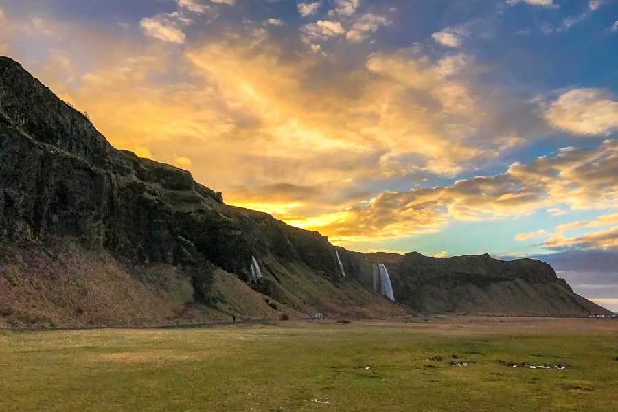 Sun brightens the sky over beautiful Seljalandsfoss on the final day of our Iceland road trip itinerary.