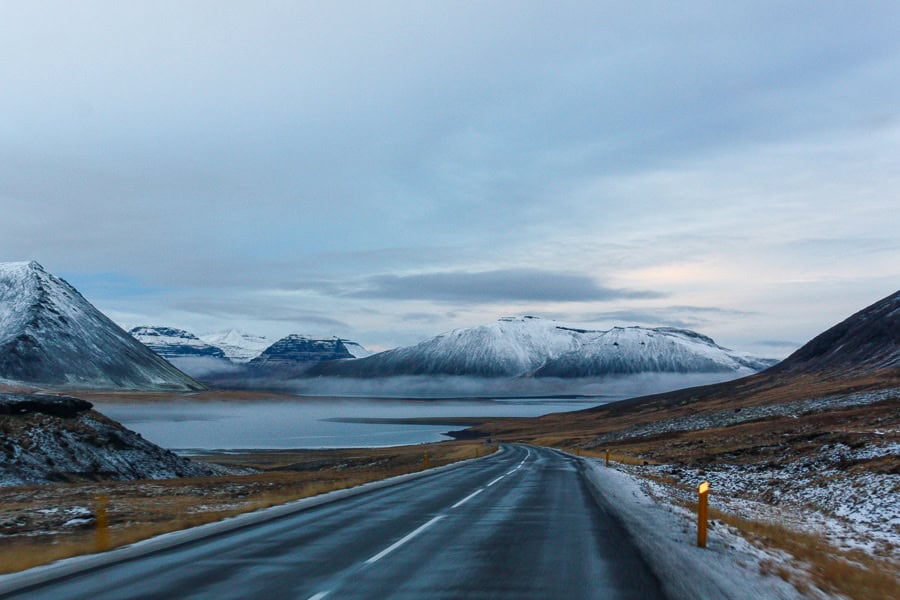 A road past lakes and mountains on the Snaefellsnes Peninsula has a surreal, otherworldly feel during winter in Iceland.