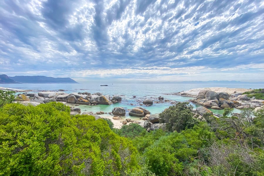 Turquoise water laps the shore on a visit to Boulders Beach – a perfect Cape Town day trip.