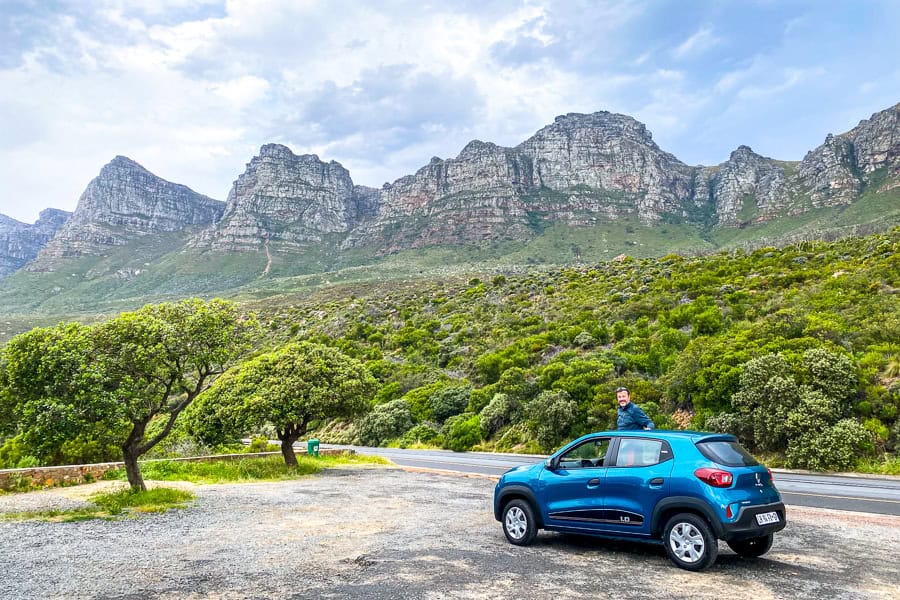 Car parked in a scenic coastal spot with mountain views, a benefit of renting a car for driving in cape town and surrounds.