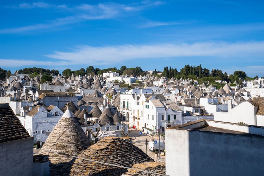 A view over the cone-shaped roofs of Alberobello, key stop on a Puglia itinerary.