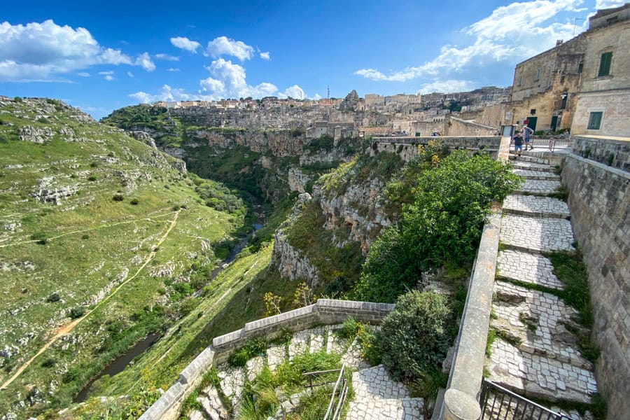 Stone stairs wind down into the valley at Matera, a highlight of a south-eastern Italian road trip.