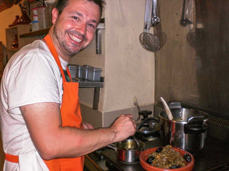 A visitor cooking a tagine during a Marrakech cooking class.