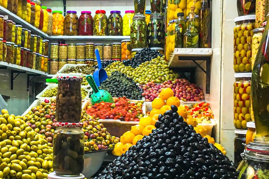 A colourful shop selling olives, pickles and all manner of preserves – just one of the tasty stops on a Marrakech food tour.